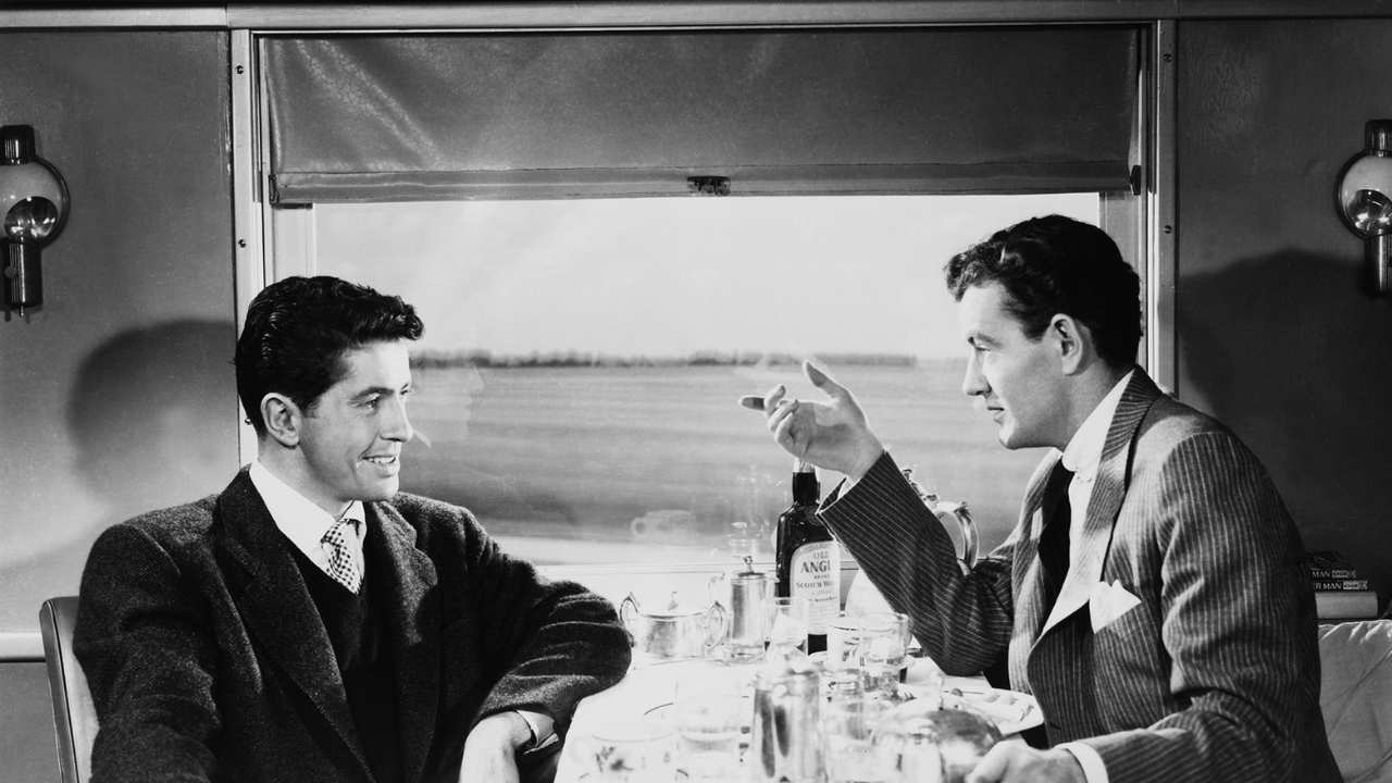 two men talking on a train